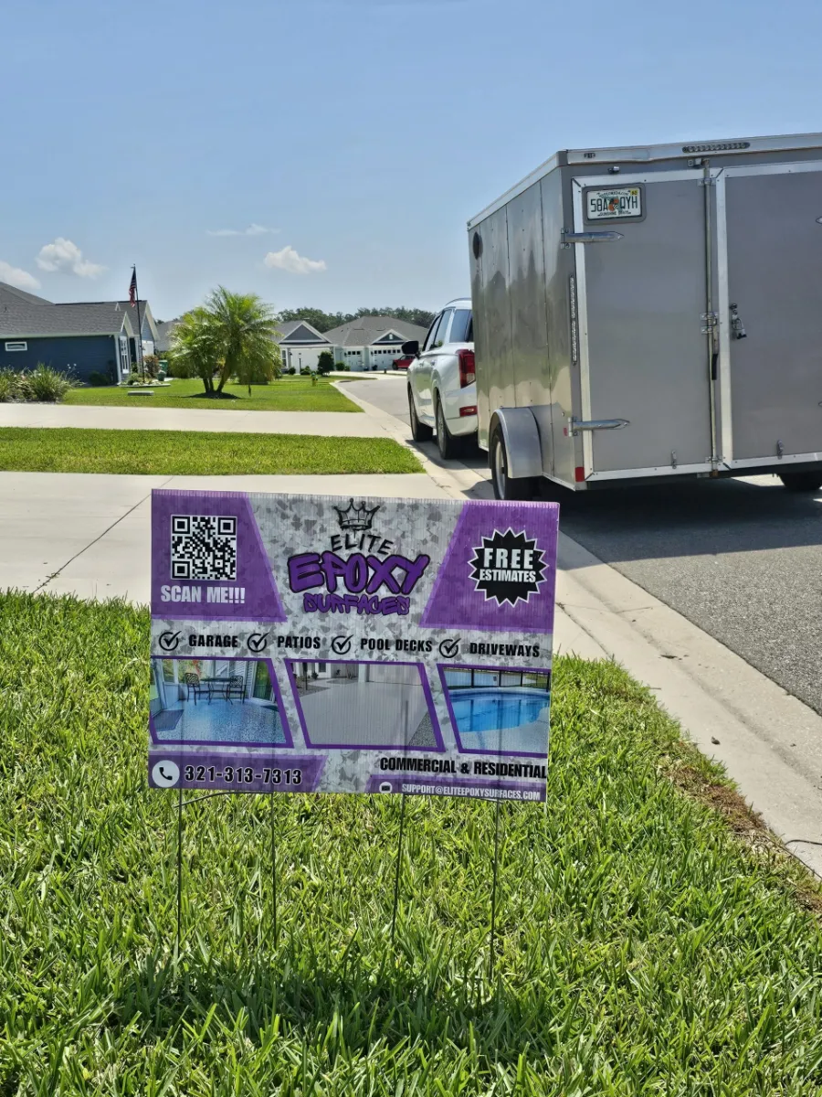 Branded work trailer and yard sign in residential neighborhood